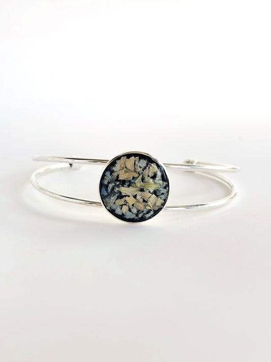 Stylish Amara Cuff with black and white floral design preserved in resin, silver finish.
