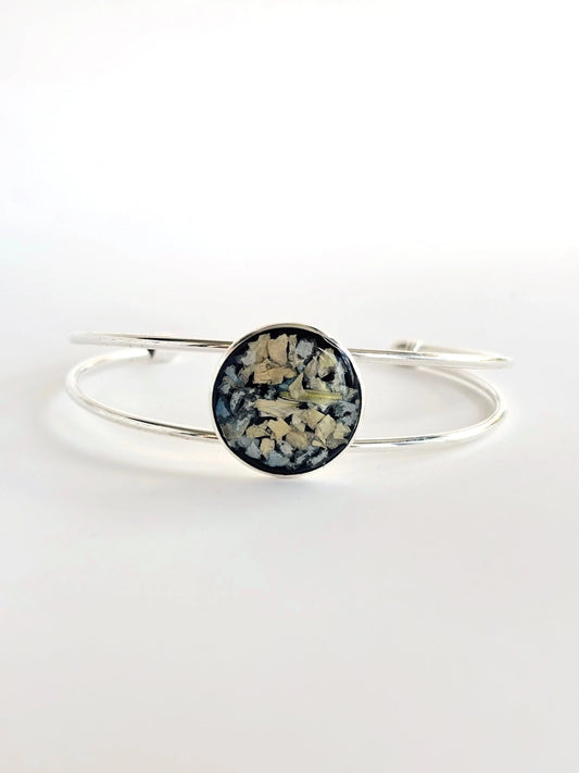 Stylish Amara Cuff with black and white floral design preserved in resin, silver finish.