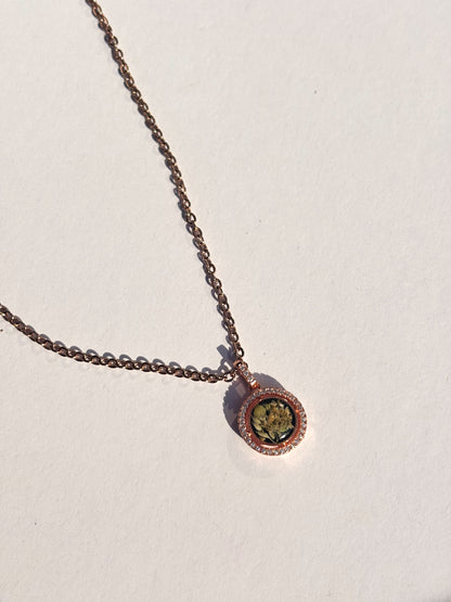 Stylish display of the Aurora Necklace showcasing the sparkling halo around its preserved flower charm.
