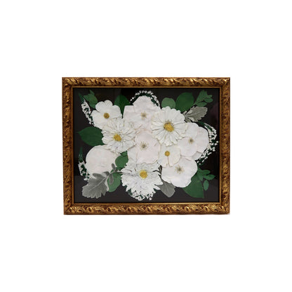 Close-up of Ornate Gold Pressed Floral Frame emphasizing custom floral preservation highlighting intricate details of dried blooms.