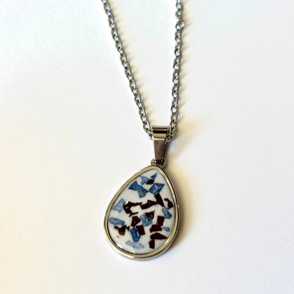 Bloomsake Clara Necklace silver teardrop pendant with blue and burgundy flower petals in white resin, full necklace view.