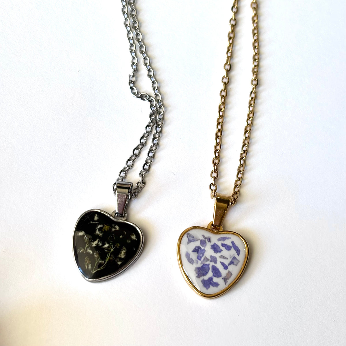 Bloomsake heart pendant necklace shown in both gold and silver finish with preserved flower petals in resin.